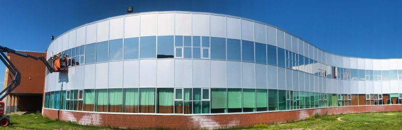 Solar window films being applied to the windows of a school.